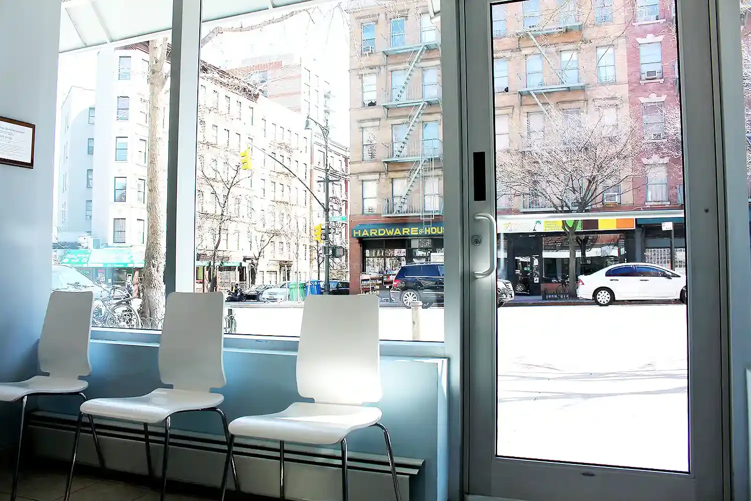 Waiting room chairs by the window overlooking Columbus Avenue